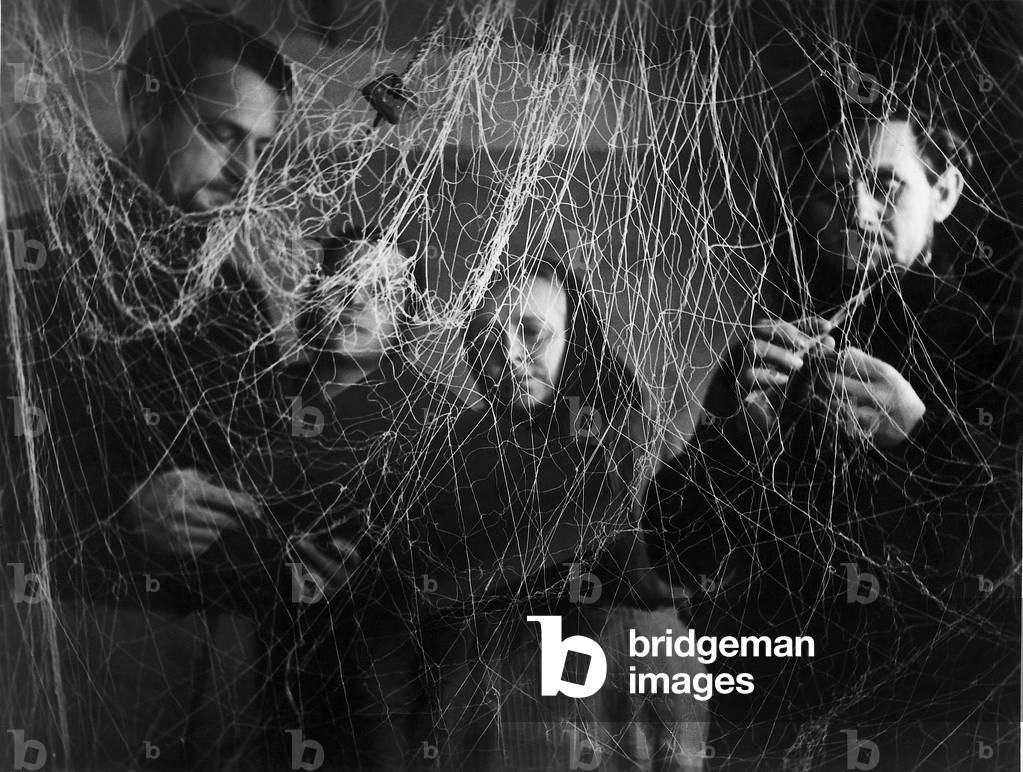Fishermen patch nets (b/w photo)