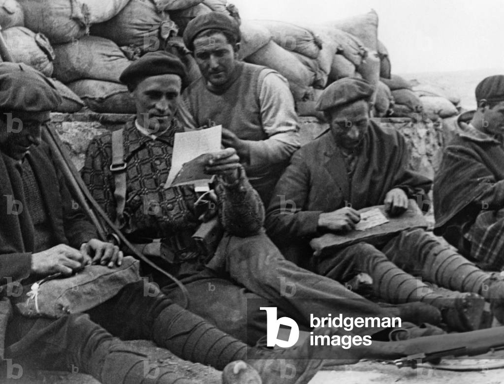 Spanish national volunteers read military letters, 1937