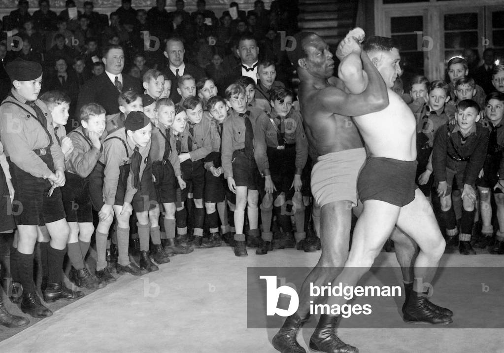 John Essaw and Franz Kochansky wrestle before Hitler Youth members in the  Circus Busch, 1933 (b/w photo)