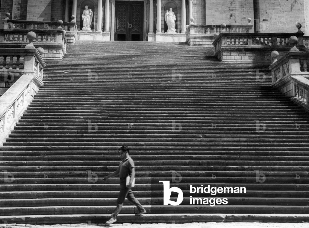 Man walking down the steps of the Cathedral of Saint Mary in Girona, 1963 (b/w photo)