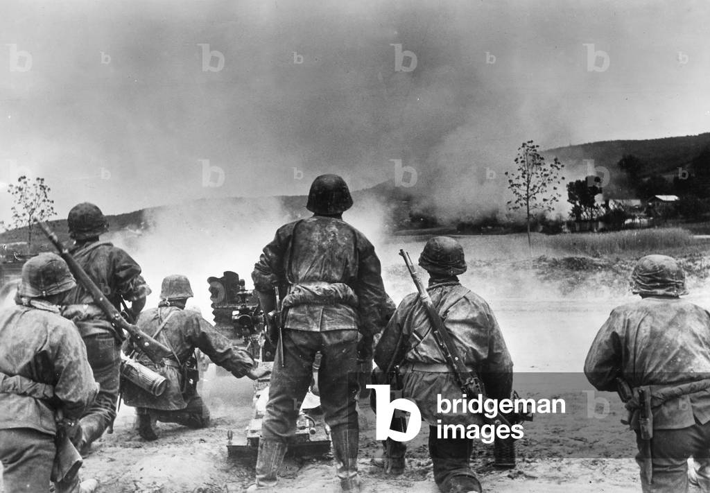 Soldiers of the Waffen-SS bombards partisans in a village, 1941 (b/w photo)