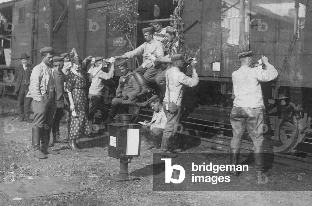German soldiers write postcards on their way to France, 1914  (b/w photo)
