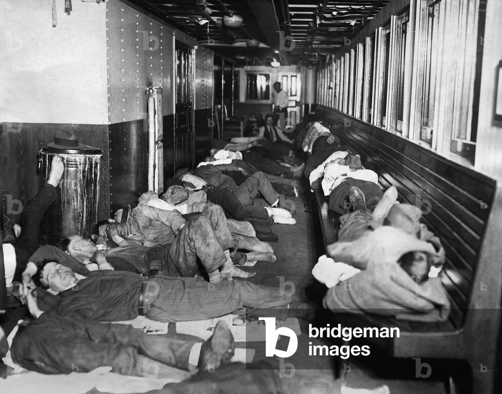 Homeless people stay overnight on a steamer during the Great Depression, 1930 (b/w photo)