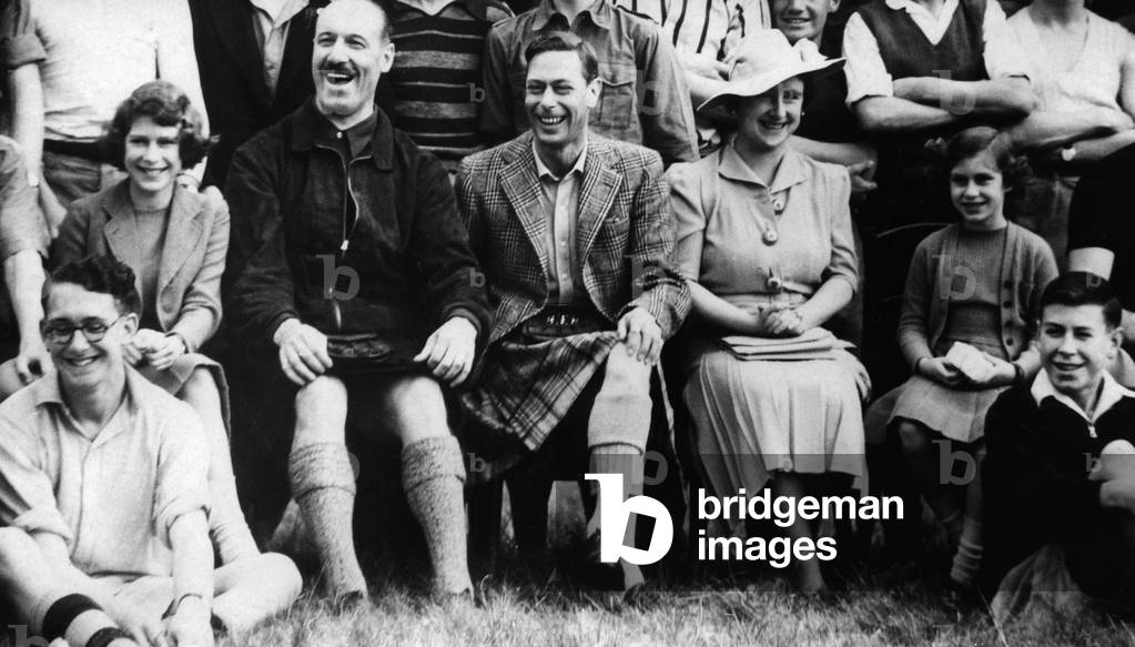 Queen Elizabeth, King George VI, Princess Elizabeth and Princess Margaret Rose visiting a boys' camp, 1939 (b/w photo)
