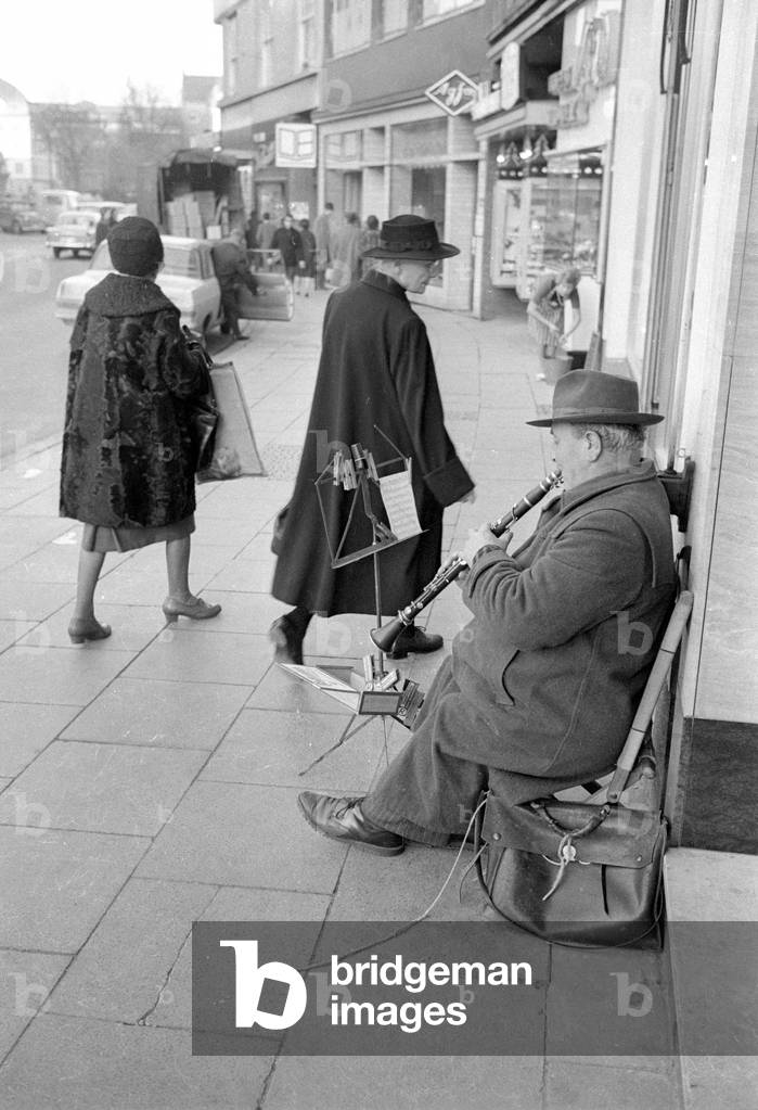 Street musician in Bonn, 1964 (b/w photo)