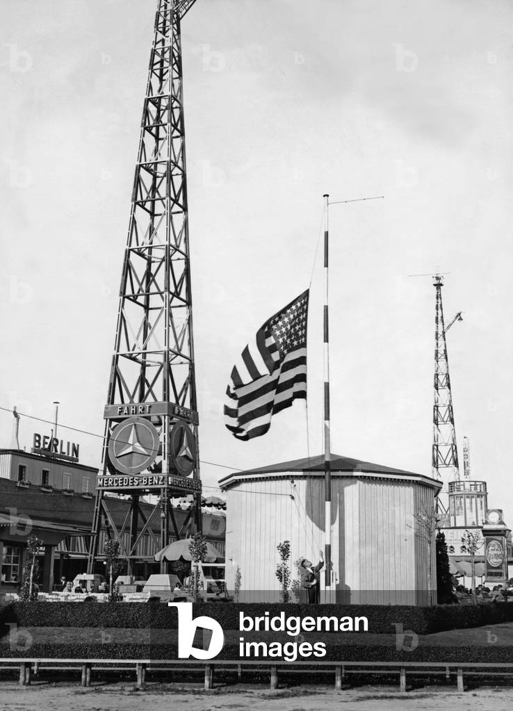 Hoisting of the American flag in honor of Wiley and Post, 1931 (b/w photo)