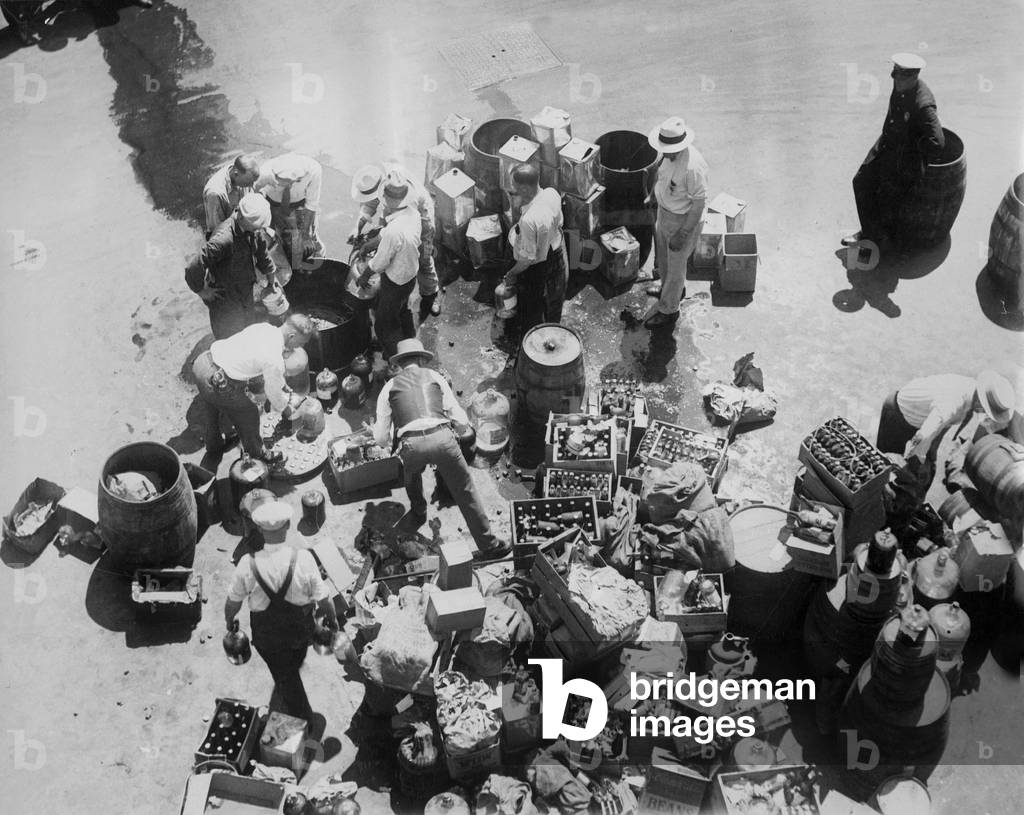 Destruction of alcohol at the time of the Prohibition in the United States, 1927 (b/w photo)