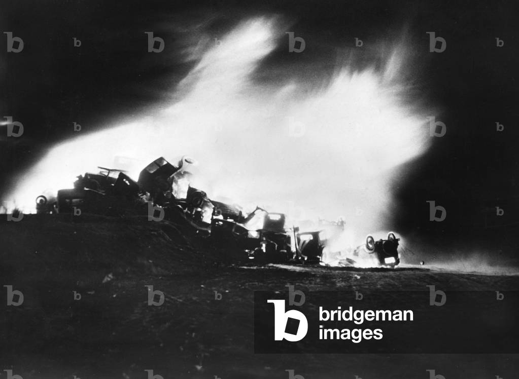 Incineration of discarded automotive parts in Bristol, 1938 (b/w photo)