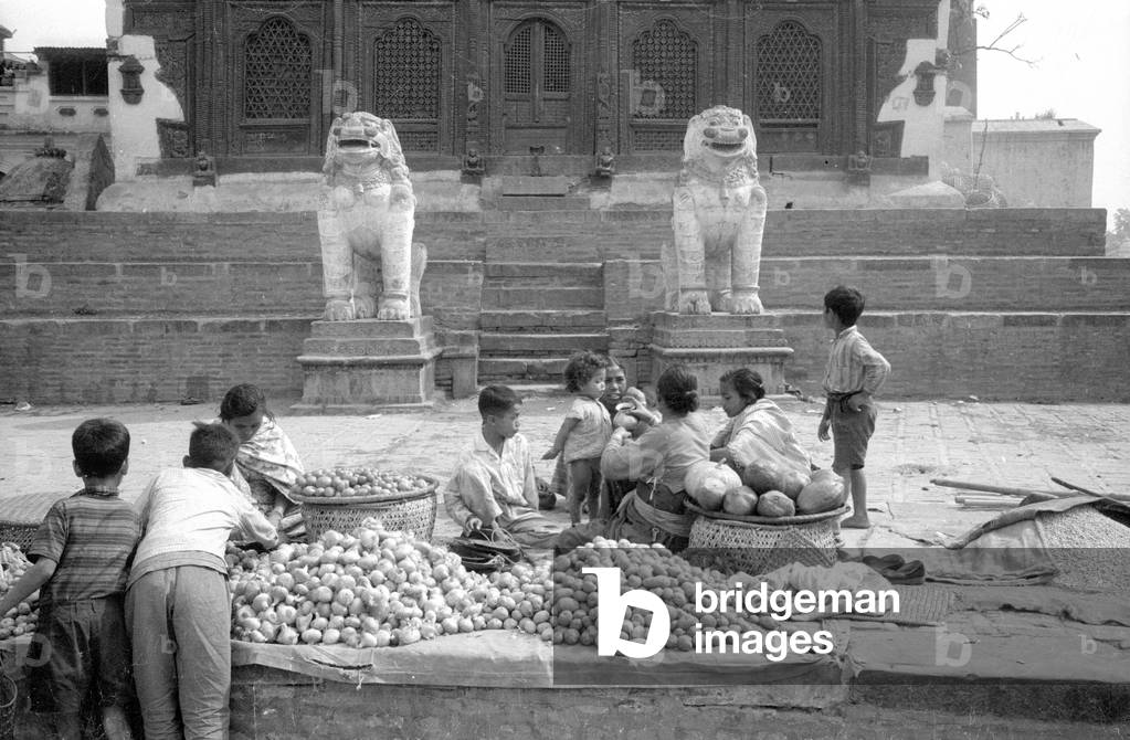 Fruit seller in front of a temple, 1966 (b/w photo)