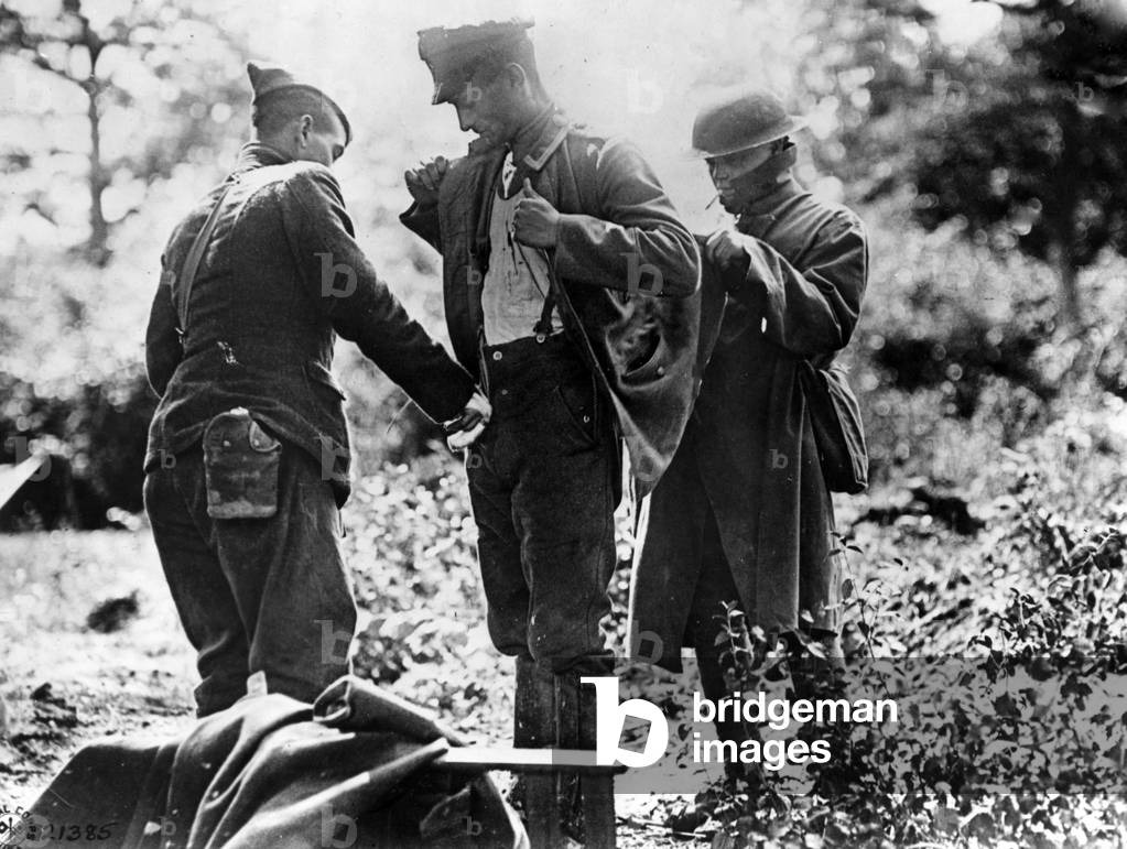 Inspection of a German prisoner, 1918 (b/w photo)