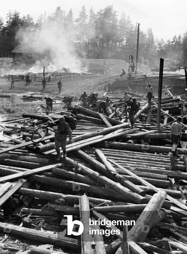 German troops passing a destroyed bridge in France, 1940