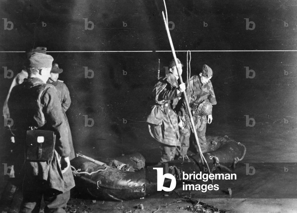 German paratroopers crossing a river in the night in the Netherlands, 1945 (b/w photo)