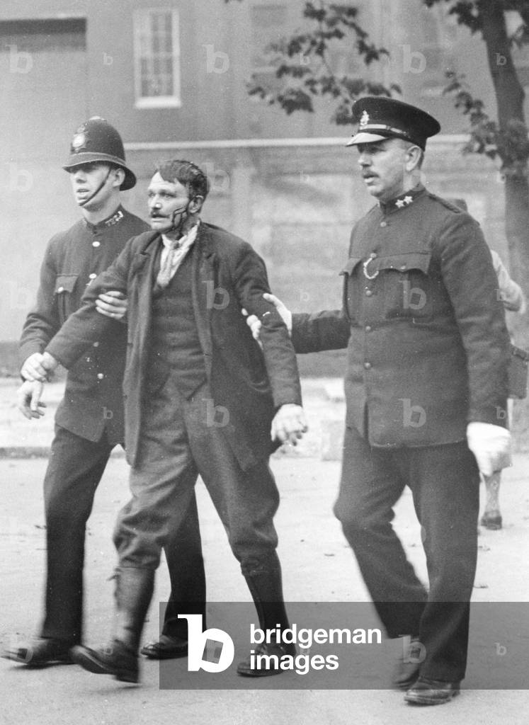 Policemen lead a demonstrator away in London, 1930 (b/w photo)