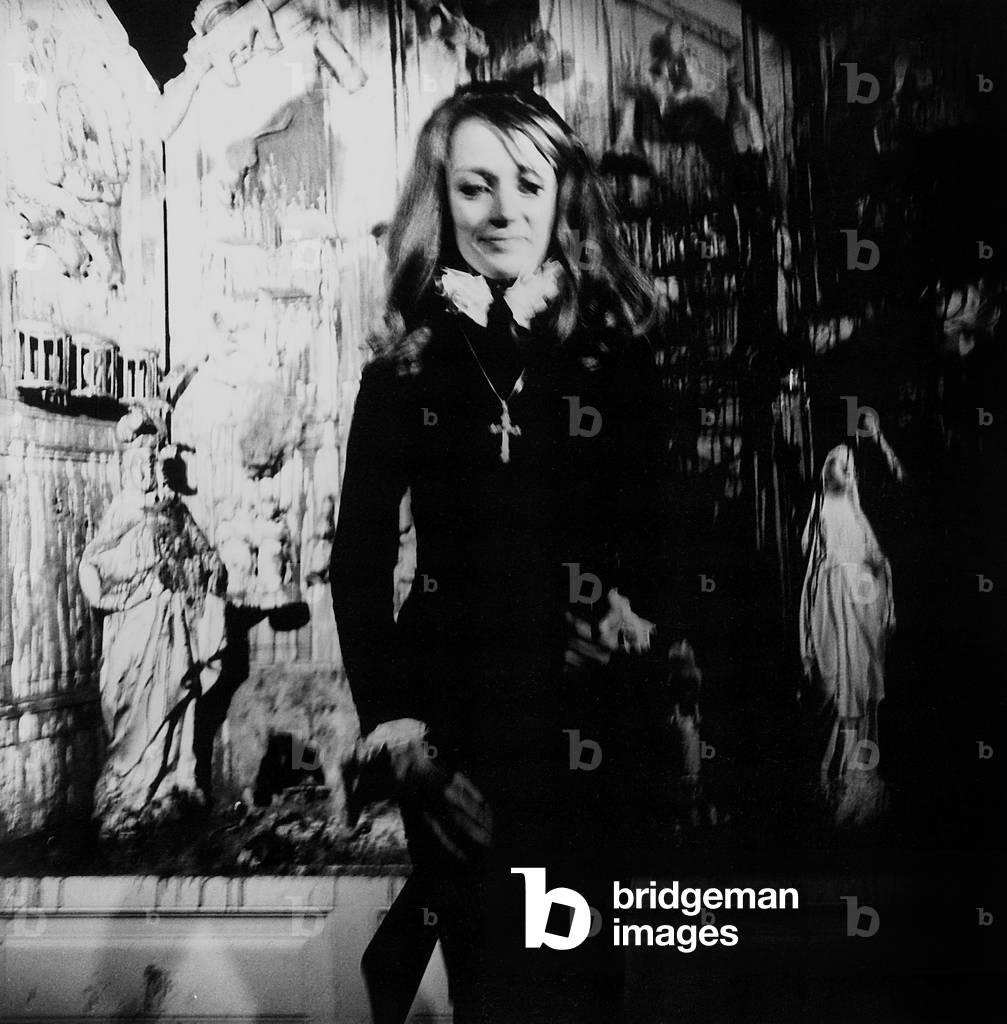Niki de Saint Phalle, the gun still in her hand, in front of a 'shattered' altar in the art project of the 'New Realists' at the Galleria Vittonio, 1971 (photo)