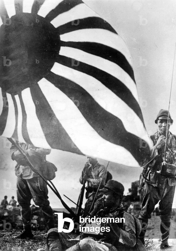 Japanese soldiers with war flag, 1941 (b/w photo)