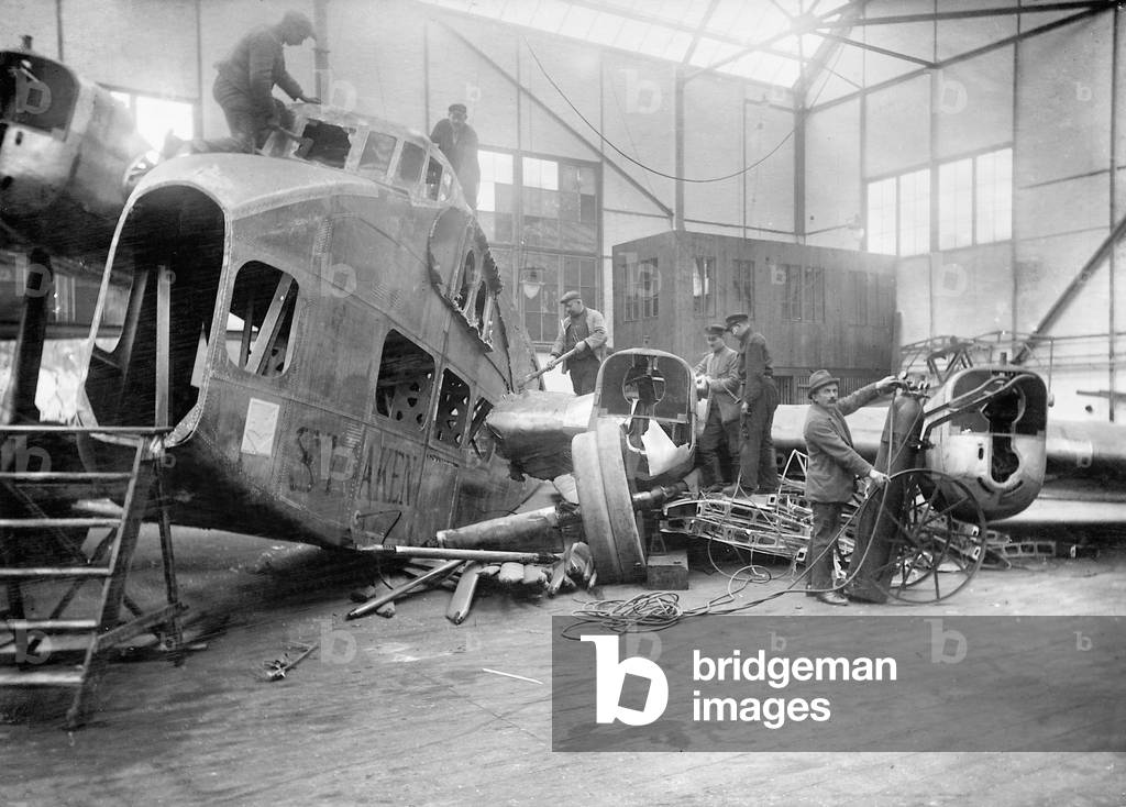 Dismantling of a German airplane, 1922 (b/w photo)
