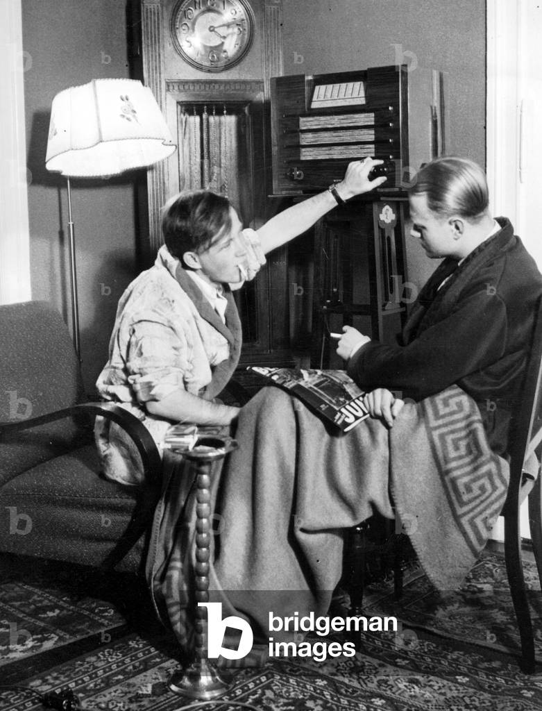 Listeners in front of a radio device, 1938 (b/w photo)