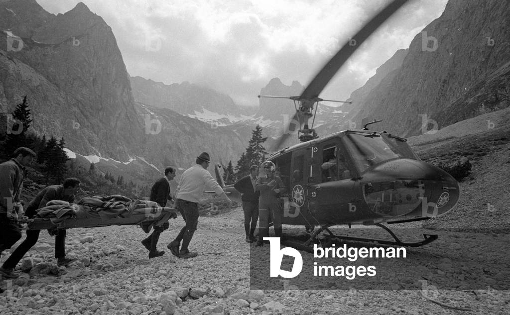 Rescue helicopter during a mission in the mountains, 1970 (b/w photo)