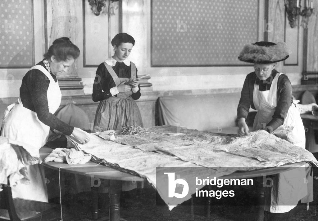 Women putting filling pillows (b/w photo)