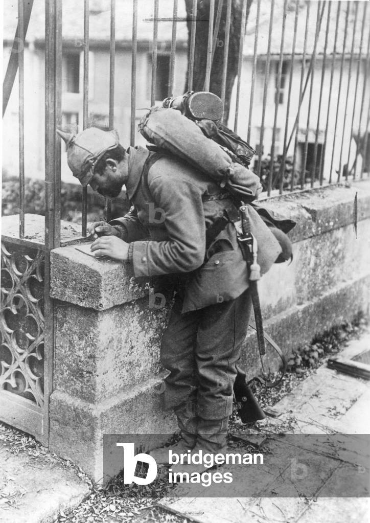 German soldier writing a letter, 1914 (b/w photo)