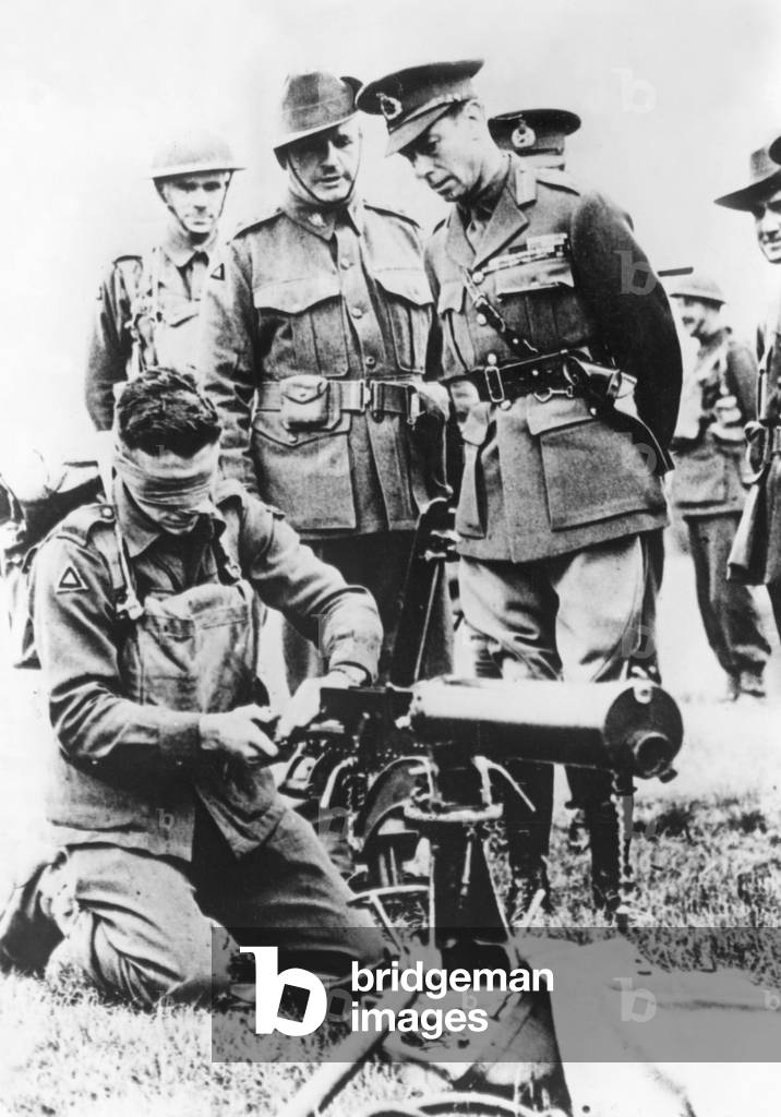 British soldier operating a machine gun while blindfolded (b/w photograph)