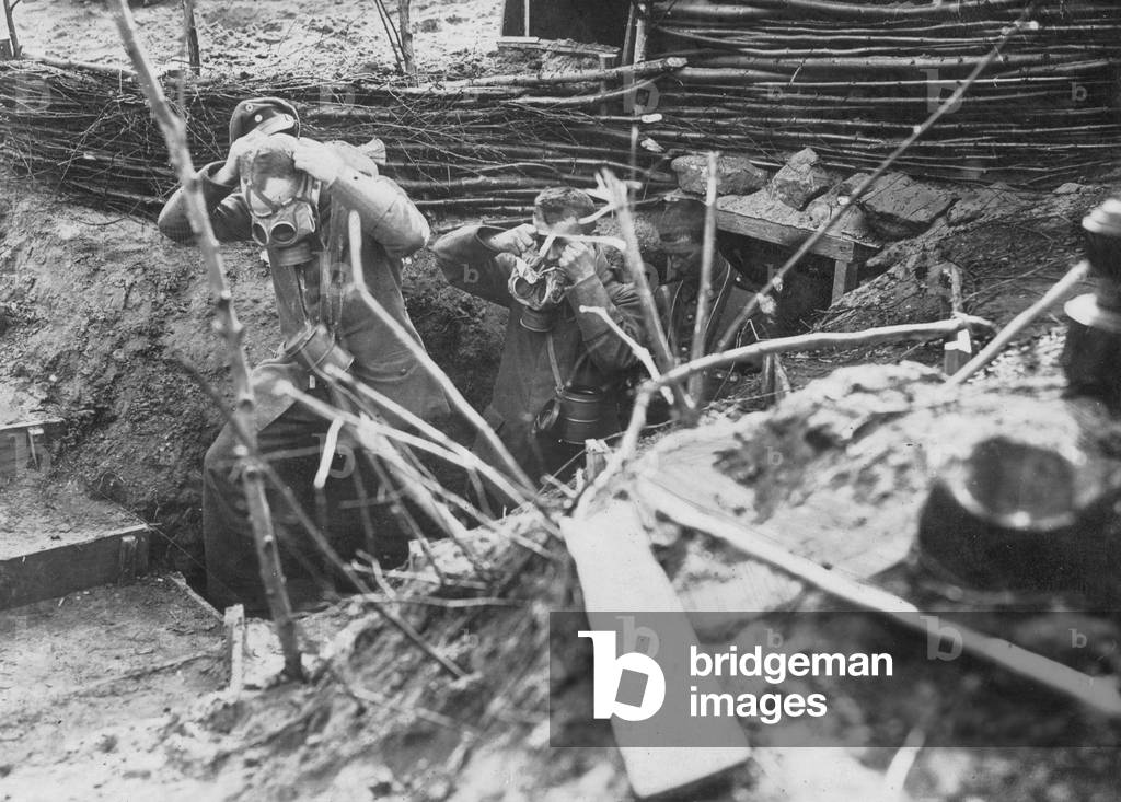 German soldiers in France leaving their trench and putting on their gas masks during a gas attack, France, 24 August 1917 (b/w photo)