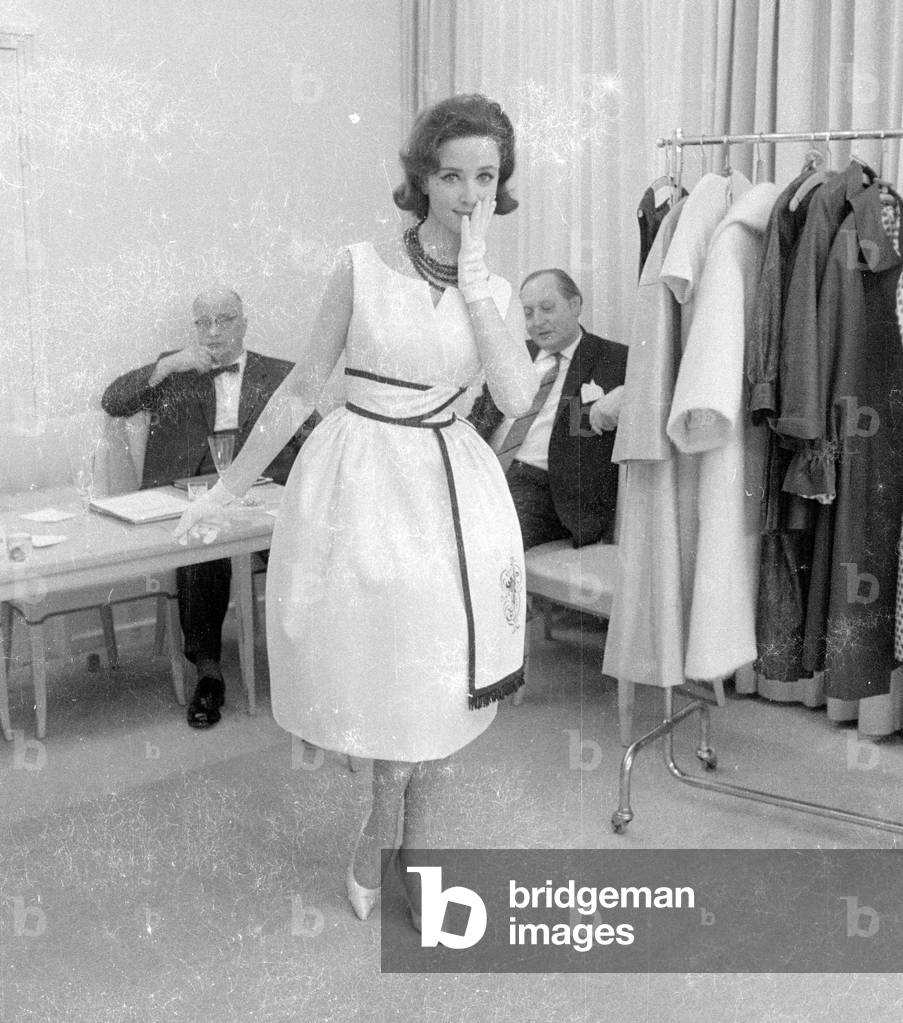 A model presents clothes from new collections, 1959 (b/w photo)