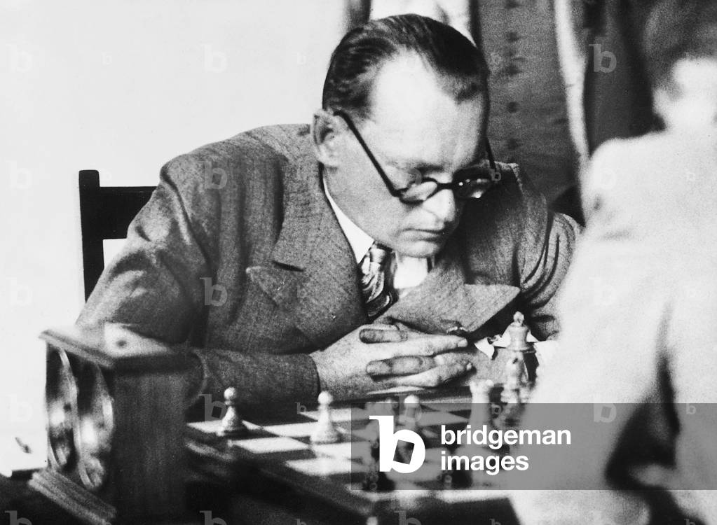 Alexander Alekhine playing chess, 1936 (b/w photo)
