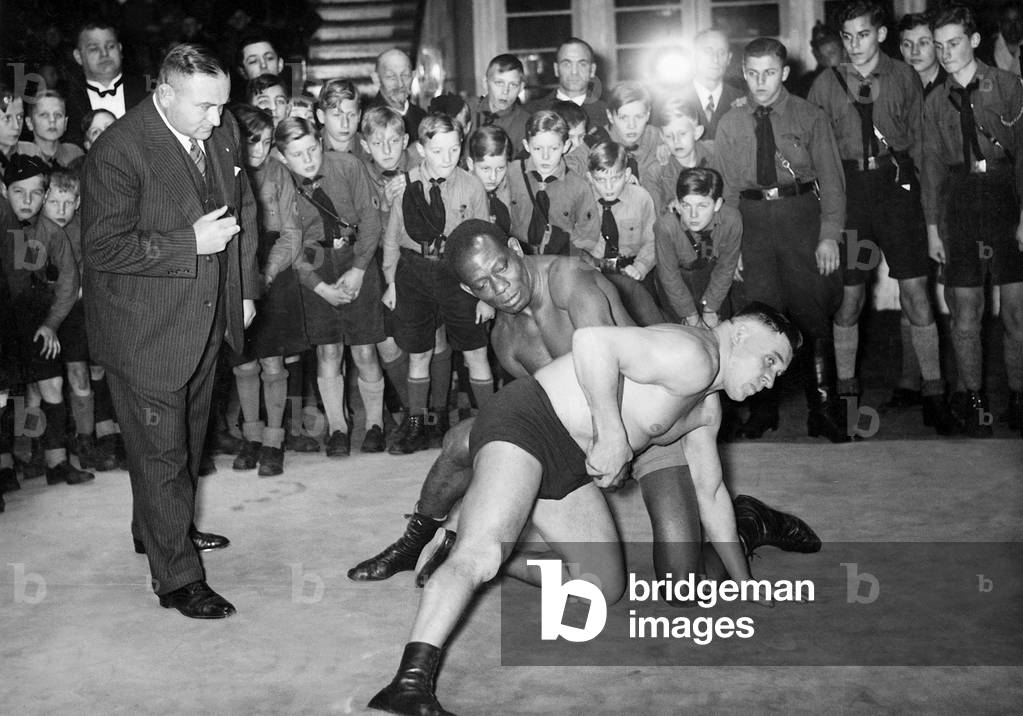 John Essaw and Franz Kochansky wrestle before Hitler Youth members in the  Circus Busch, 1933 (b/w photo)
