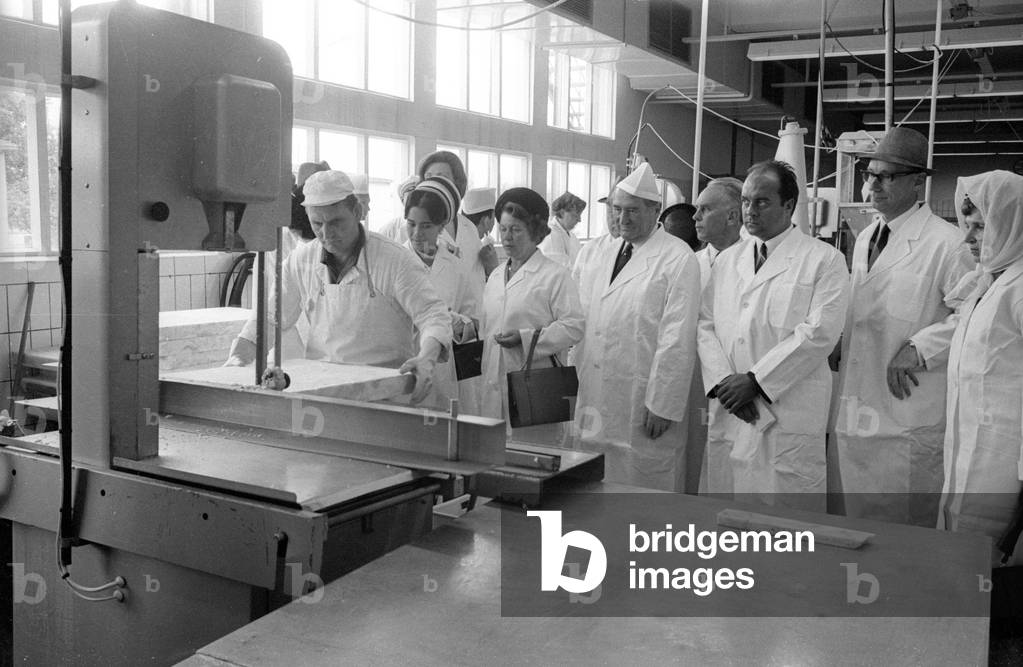 The Thai royal couple in a fish factory in Bremen, 1966 (b/w photo)