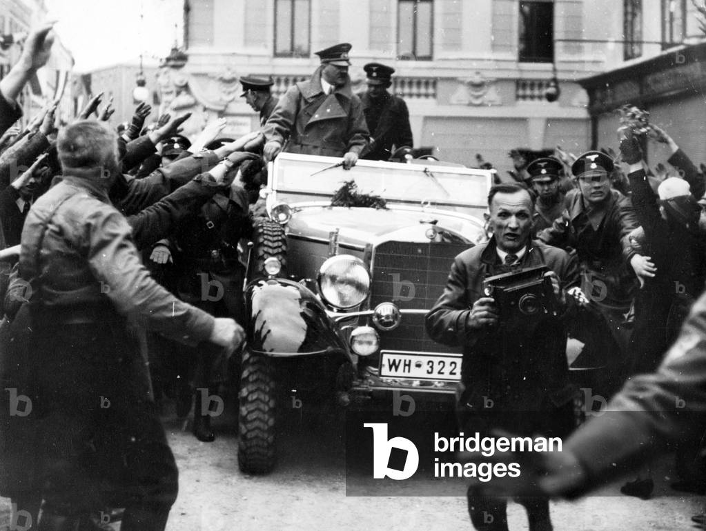 Adolf Hitler drives through Ried in Austria, 1938 (b/w photo)