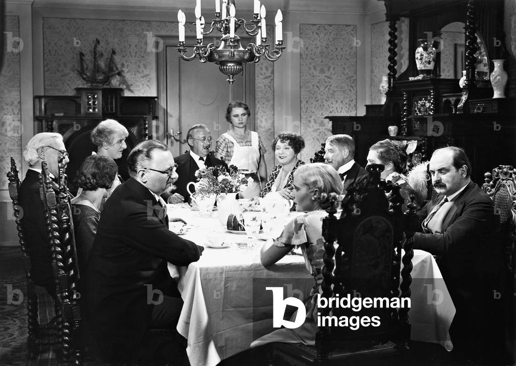 Family eating (b/w photo)