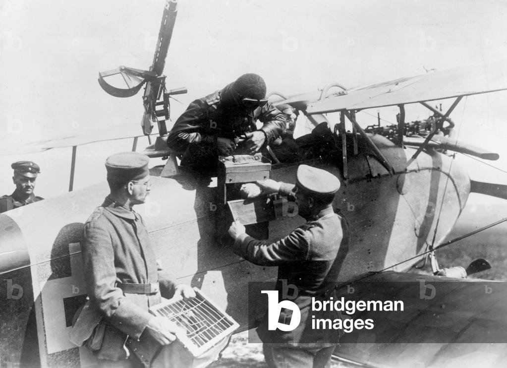 Pigeons are being loaded on a plane during the First World War (b/w photo)