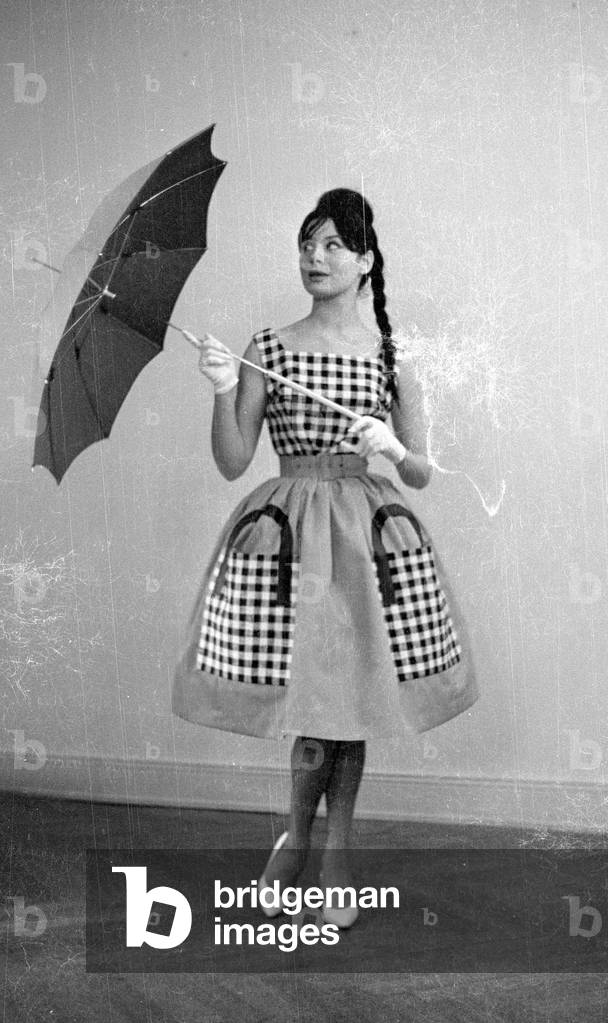 A model presents clothes from new collections, 1959 (b/w photo)