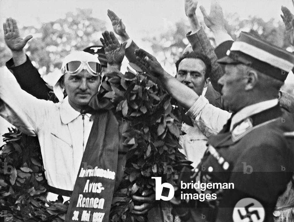 Hermann Lang with a victory wreath, 1937 (b/w photo)