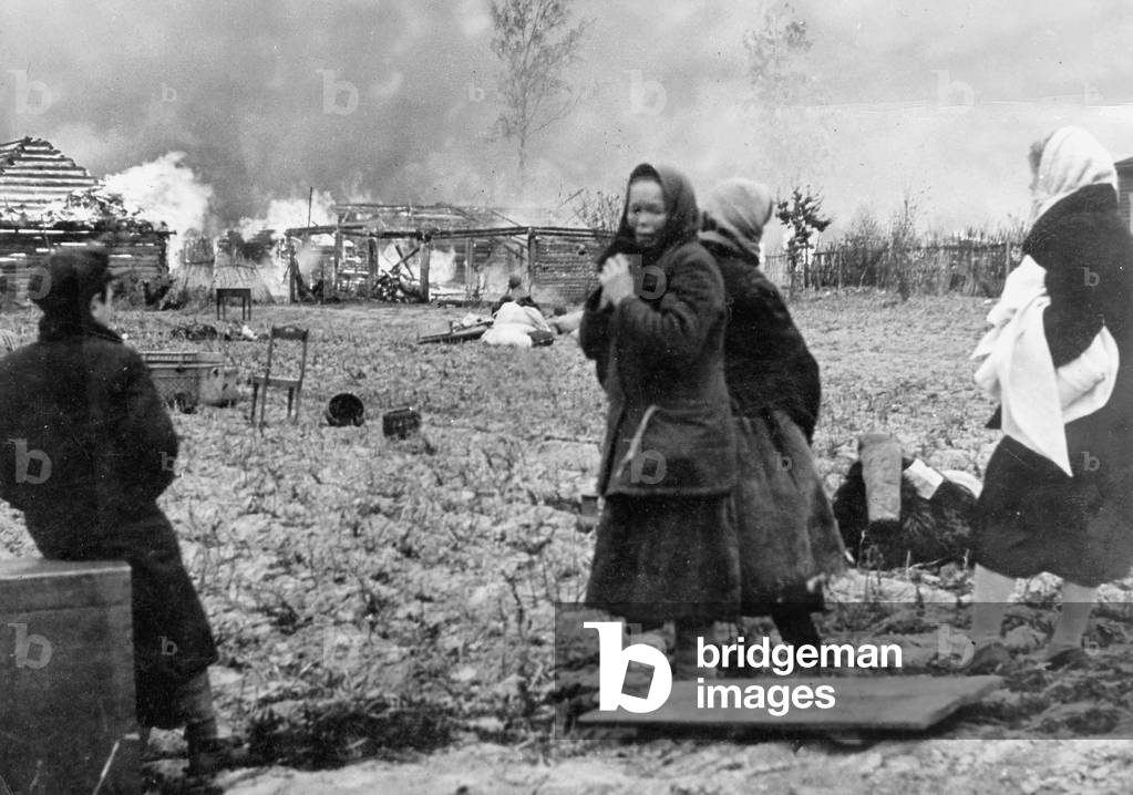 Residents of a burning village on the Eastern Front, 1941 (b/w photo)