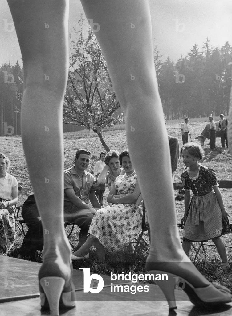 Teenagers at an outdoor fashion show, c. 1950 (b/w photo)