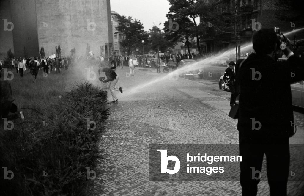 Police forces are using water canons in Berlin, 1967 (b/w photo)