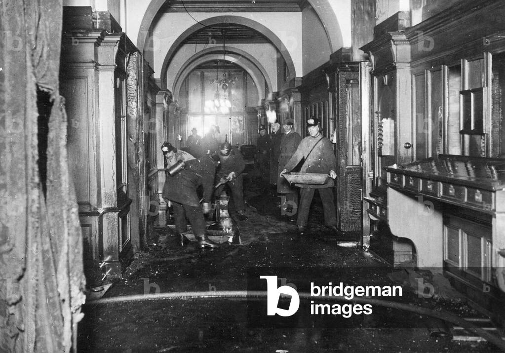 Firefighters during cleanup efforts in the Reichstag in Berlin, 1933 (b/w photo)