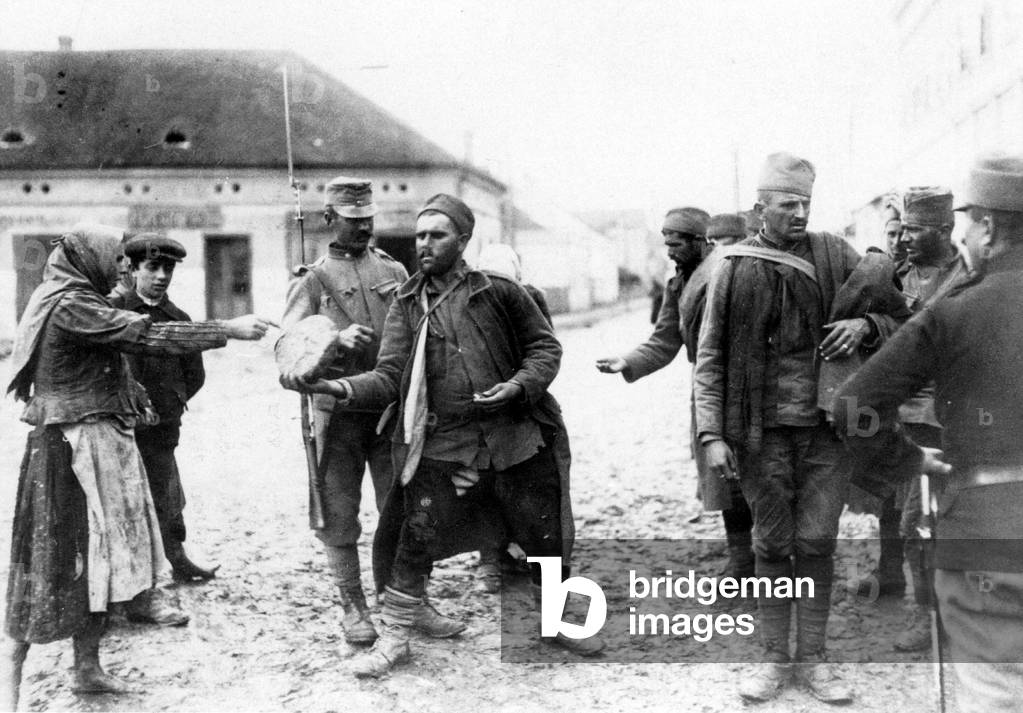 Serb prisoners buy bread, 1915 (b/w photo)