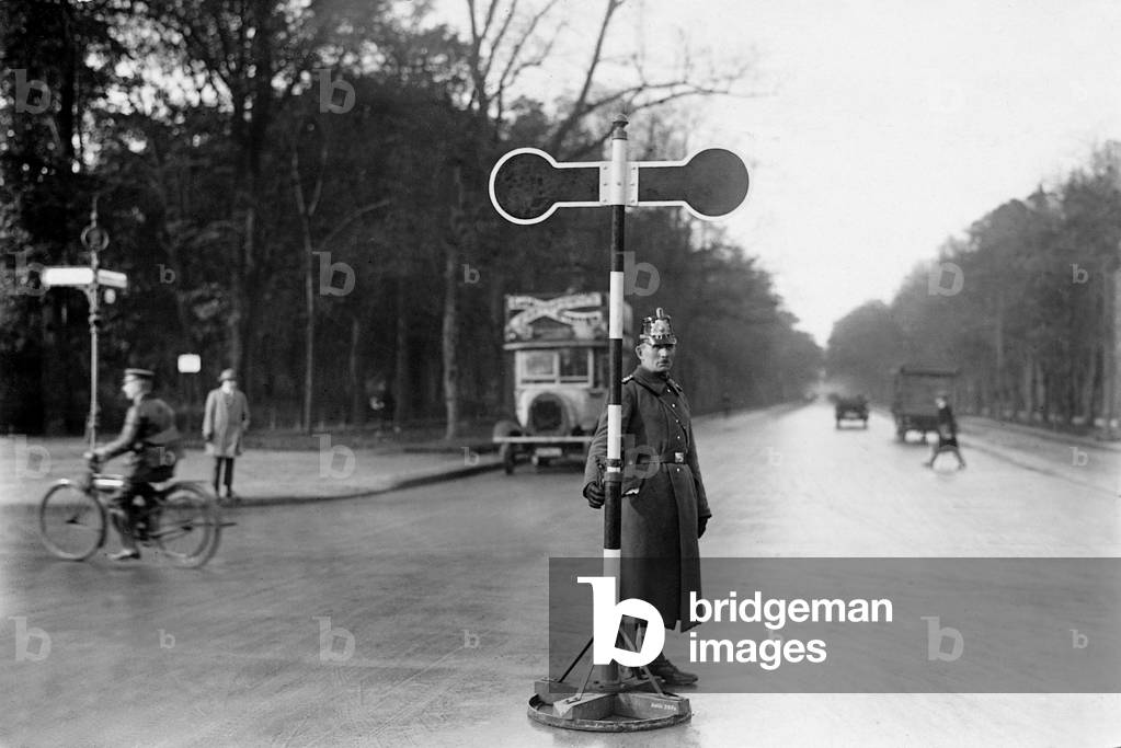 Policeman at a street crossing, 1925 (b/w photo)