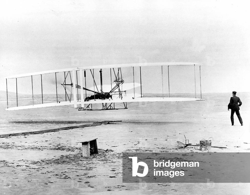 The first flight of Orville and Wilbur Wright with an aircraft engine, 1903 (b/w photo)