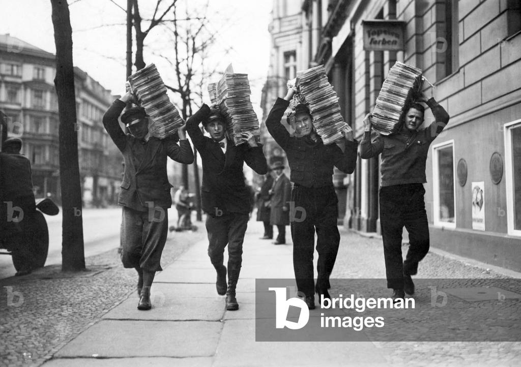 NSDAP members carrying a propaganda stack, 1932