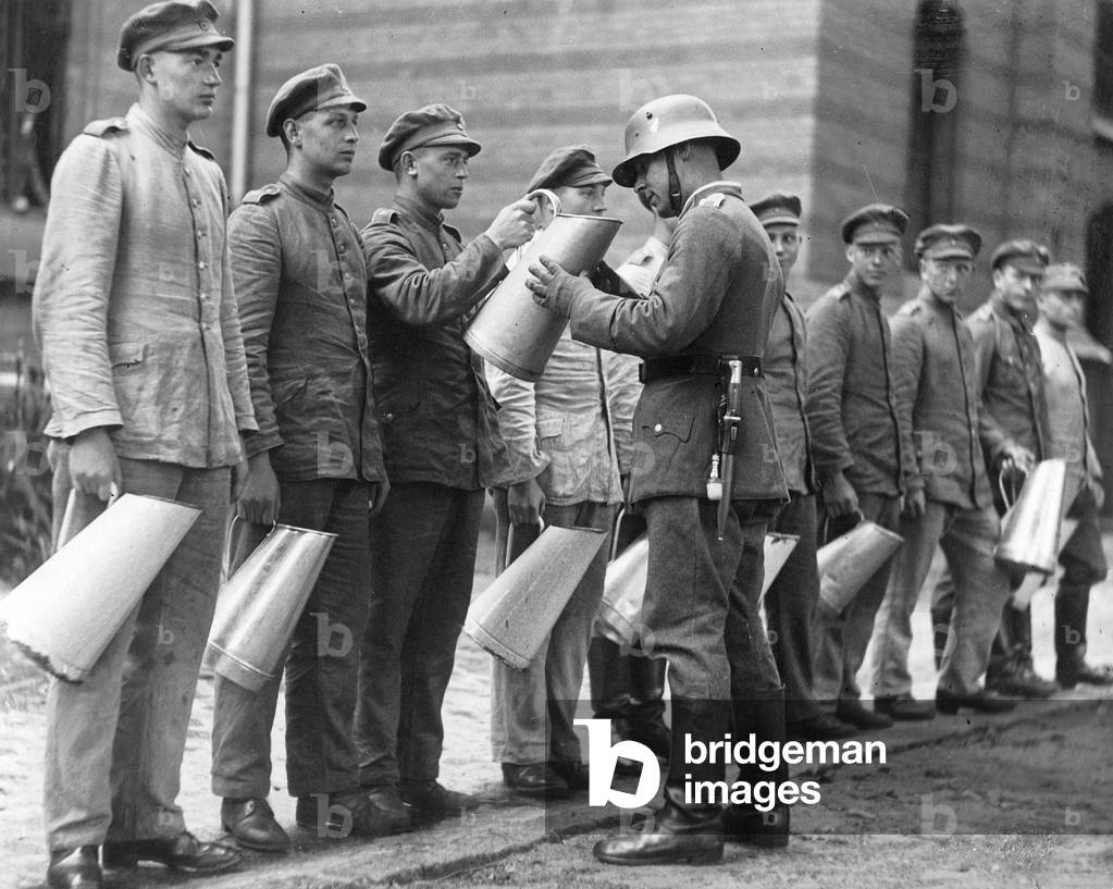 Non-commissioned officer of the National Defense Forces inspects soldiers, 1930 (b/w photo)