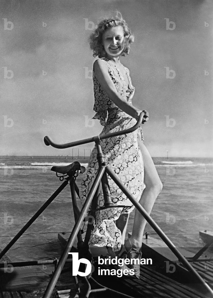 Lilian Harvey on a pedalo, 1937 (b/w photo)
