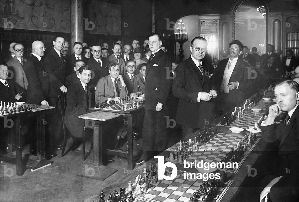 Alexander Alekhine playing simultaneous chess, 1926 (b/w photo)