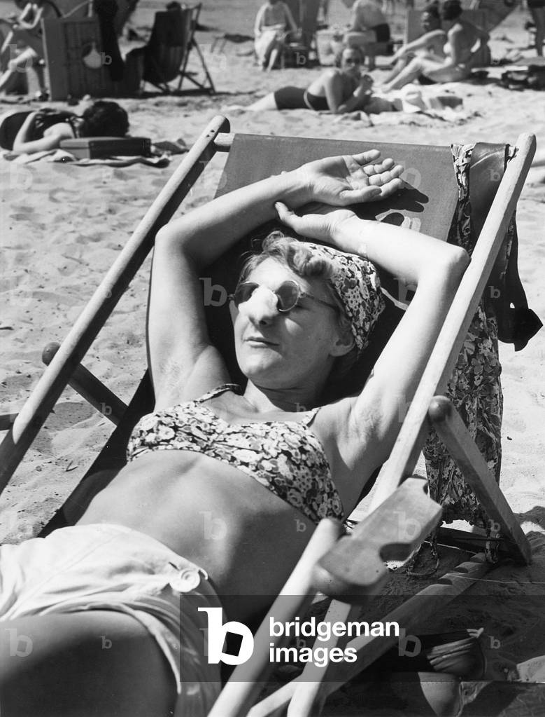 Woman sunbathing, 1939 (b/w photo)