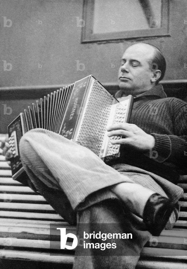 Ernst Udet playing the accordion (b/w photo)