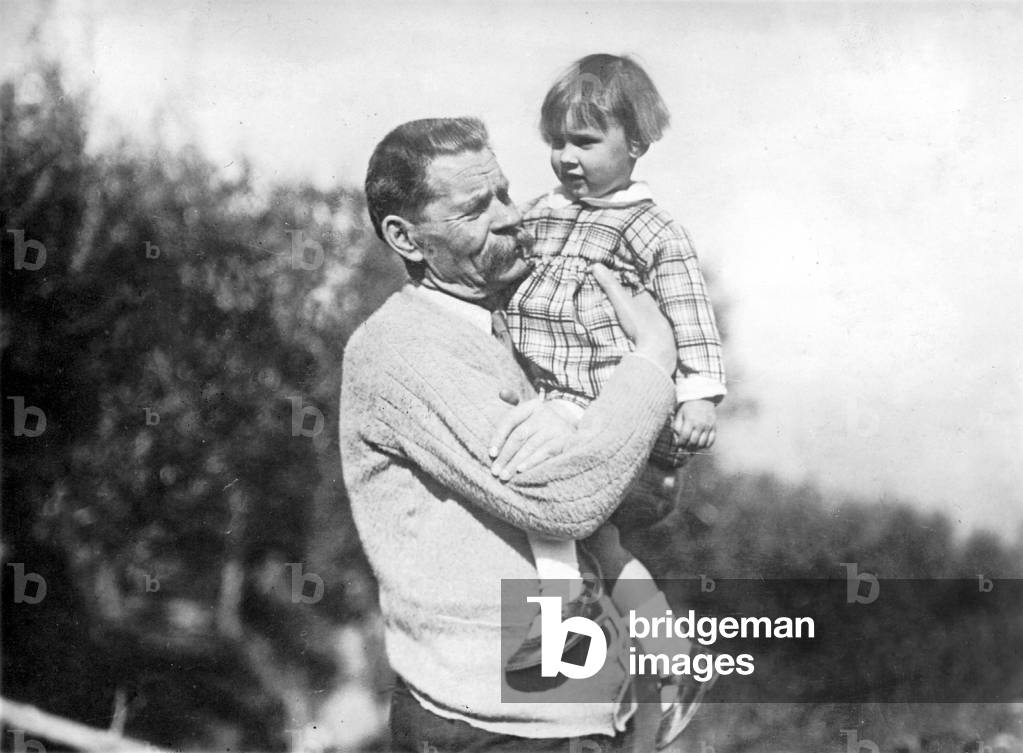 Maxim Gorky holds his granddaughter in his arm, 1928 (b/w photo)