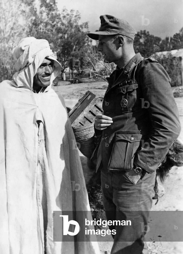 German soldier with a native, 1943 (b/w photo)